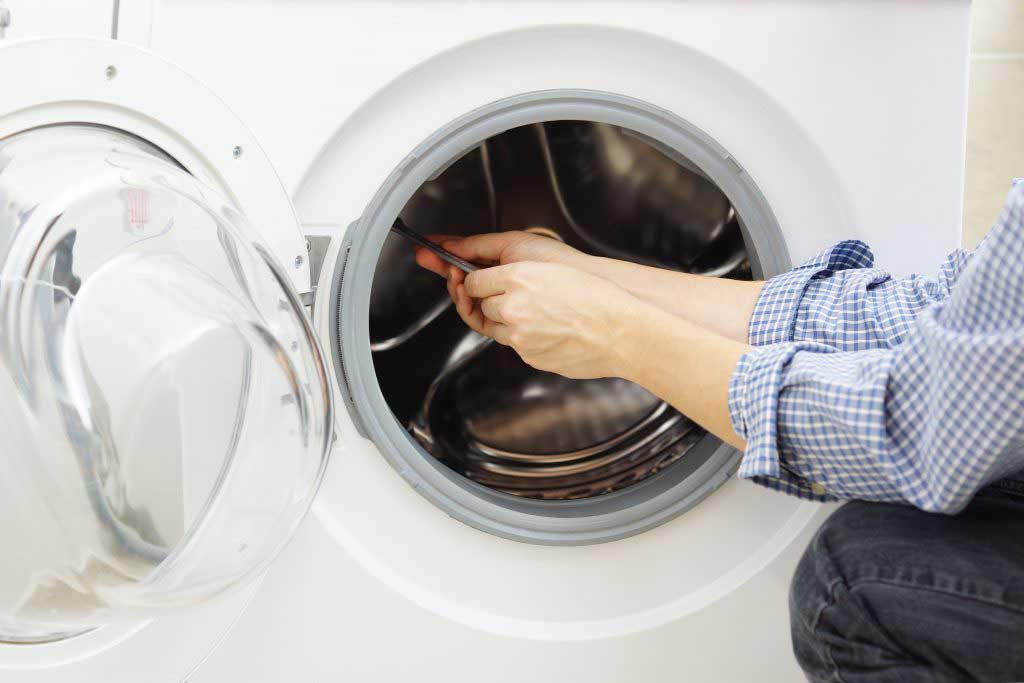 A technician fixing a washing machine