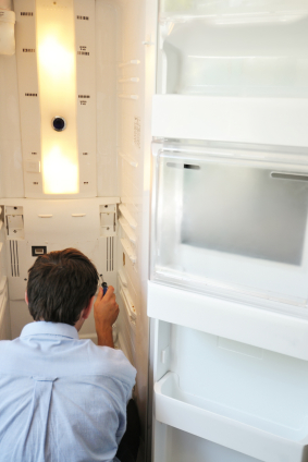 A man repairing a refrigerator