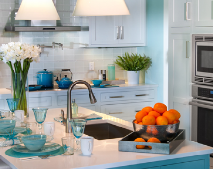 A kitchen with white countertops and blue trim