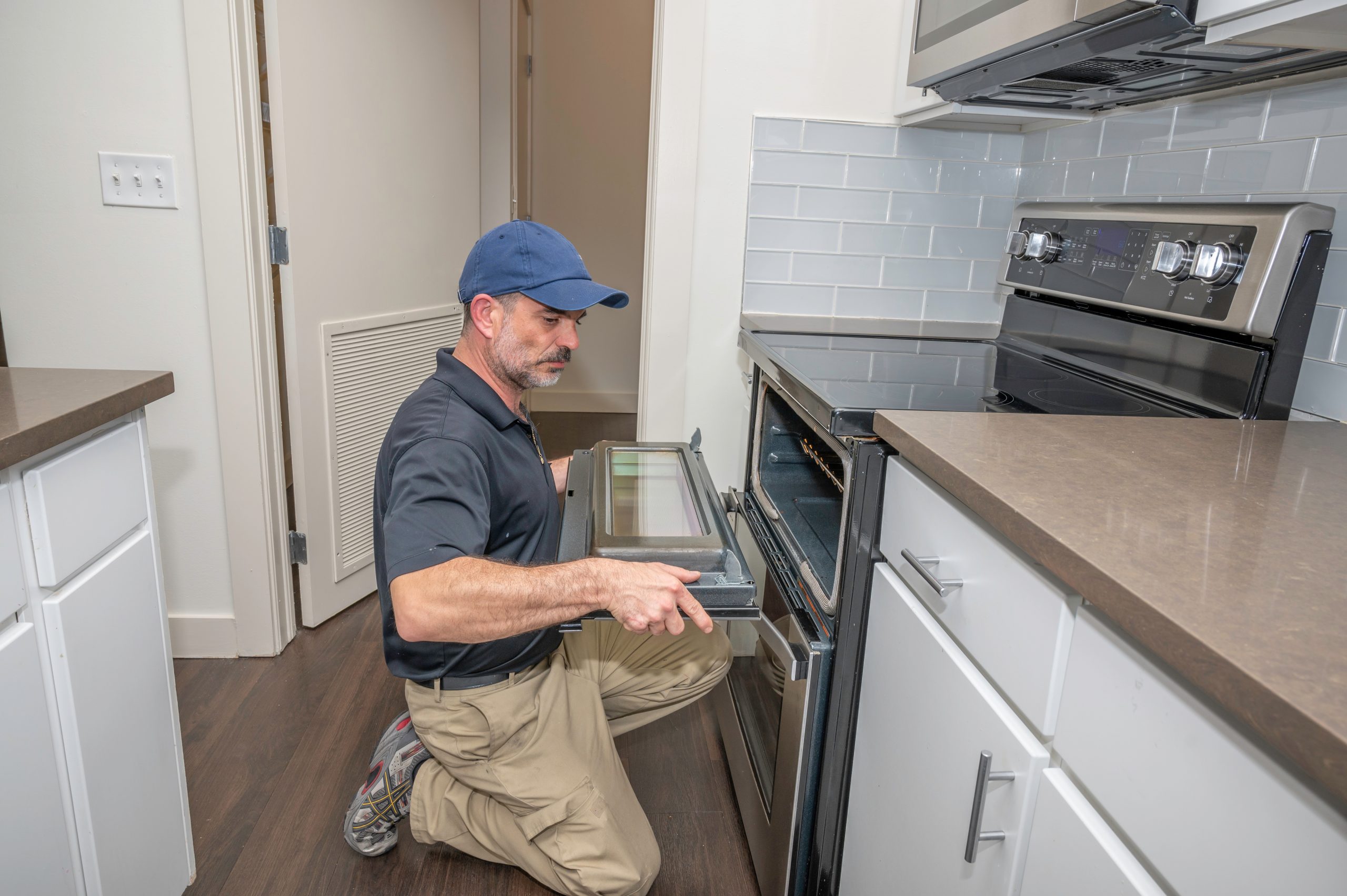 Appliance technician installing a oven door