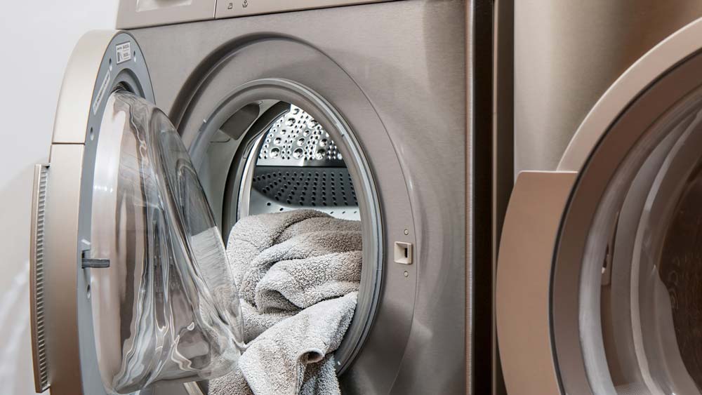 A washer/dryer with clean towels inside