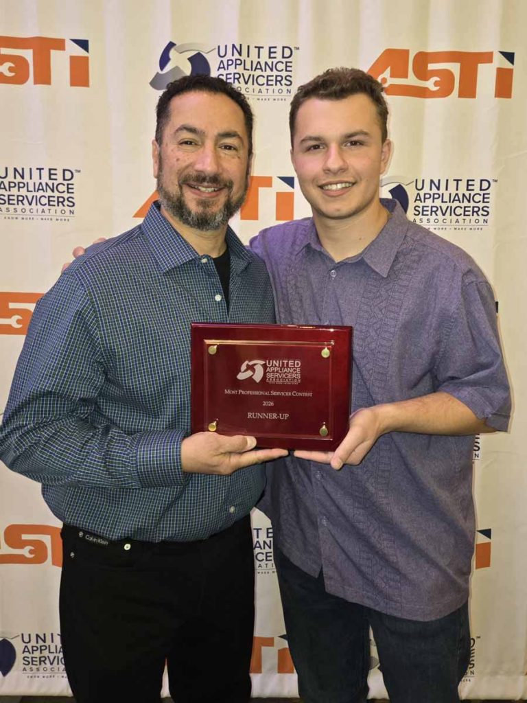 Two appliance repair technicians from Derry Appliance Repair posing with their award from the United Appliance Servicers group: 2026 runner-up for Most Professional Servicer.